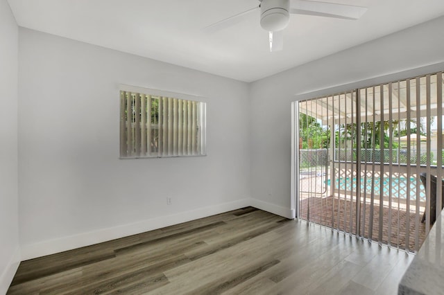 empty room featuring a wealth of natural light, hardwood / wood-style floors, and ceiling fan