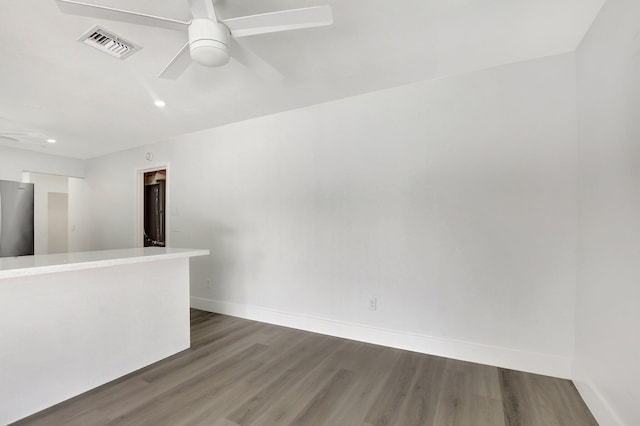 spare room with ceiling fan and dark hardwood / wood-style flooring