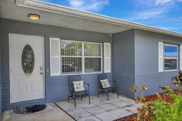 doorway to property with a patio