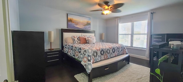 bedroom with dark hardwood / wood-style floors and ceiling fan