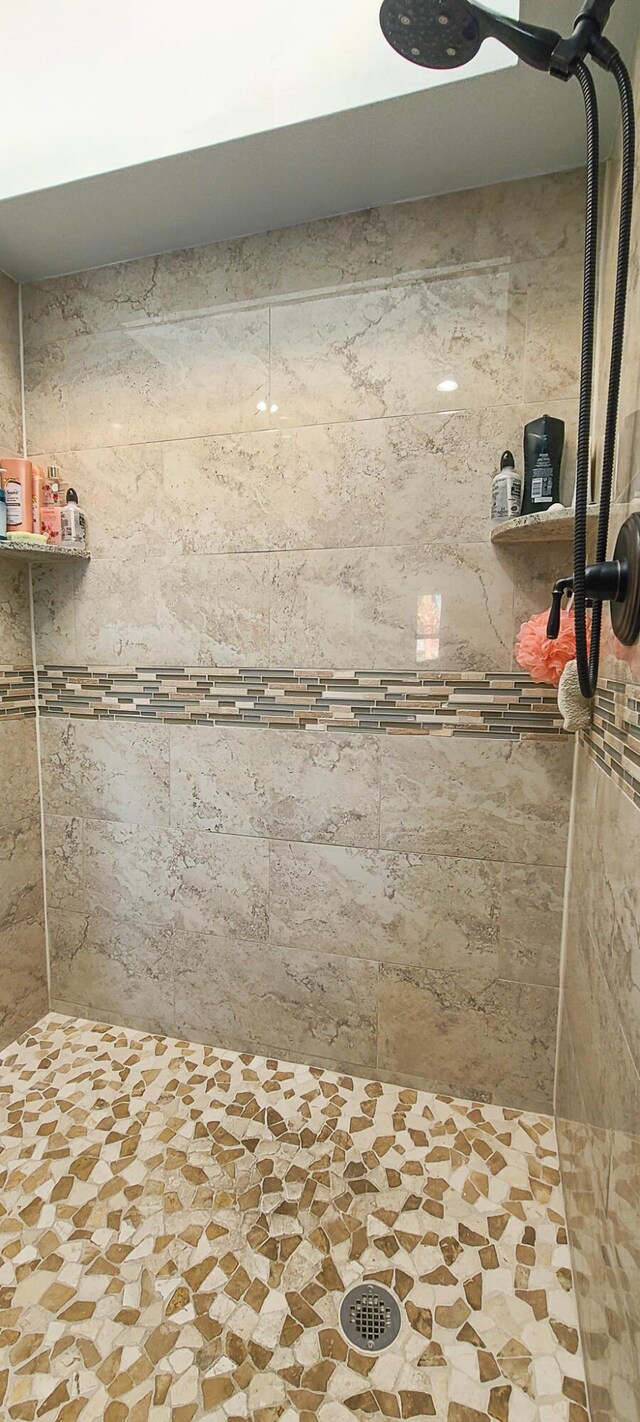 bathroom with a tile shower