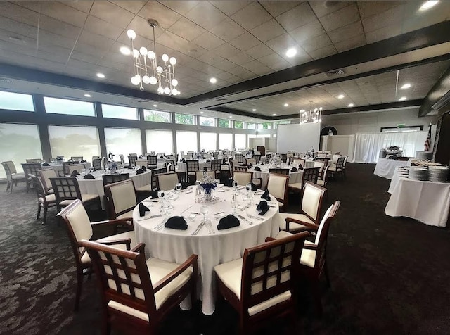 dining space featuring a chandelier, beamed ceiling, and dark carpet