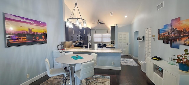 kitchen with decorative light fixtures, a high ceiling, dark hardwood / wood-style floors, and ceiling fan