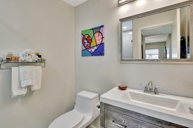 bathroom with toilet and vanity