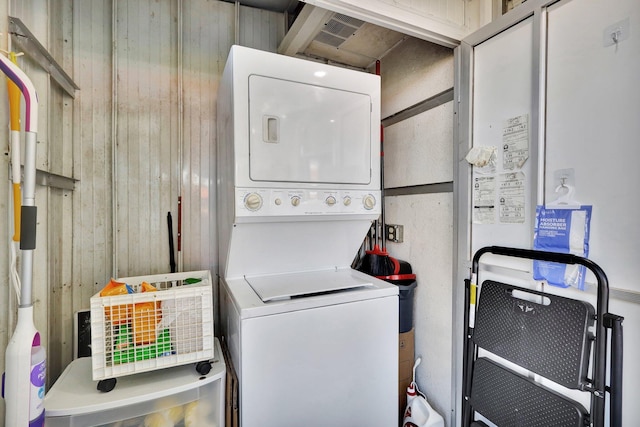 clothes washing area with laundry area and stacked washer and clothes dryer