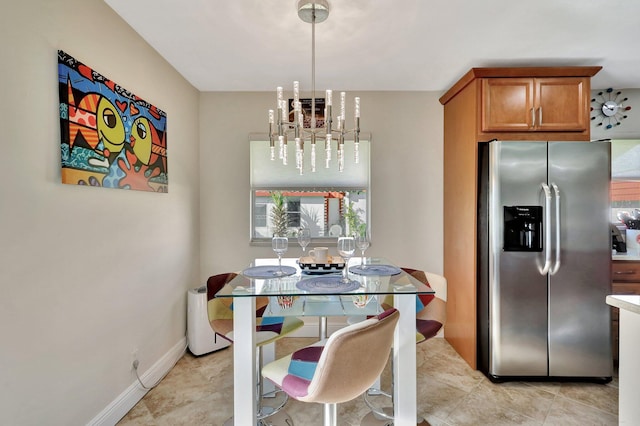 dining room featuring baseboards and an inviting chandelier