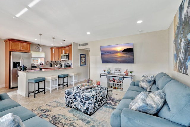 living area with light tile patterned floors, baseboards, visible vents, and recessed lighting