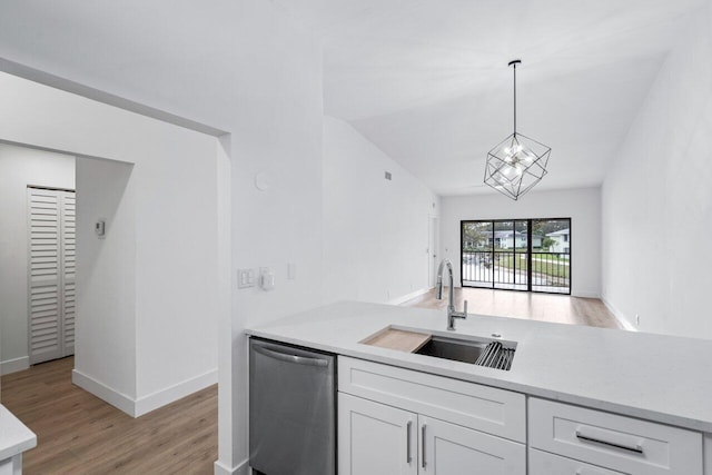 kitchen featuring dishwasher, sink, hanging light fixtures, light hardwood / wood-style flooring, and white cabinetry