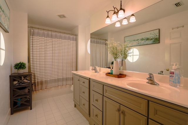 bathroom featuring tile patterned floors, vanity, and shower / bath combo with shower curtain