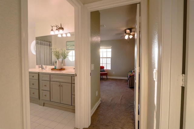 bathroom with ceiling fan and vanity