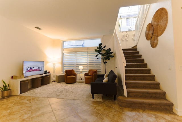 tiled living room with an AC wall unit and a wealth of natural light