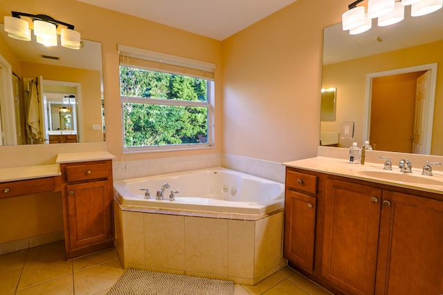 bathroom with tile patterned flooring, a relaxing tiled tub, and vanity