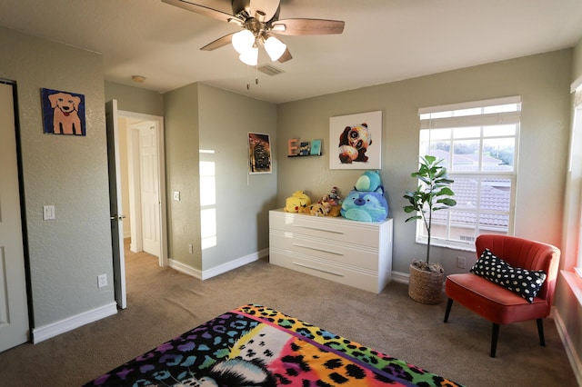 bedroom featuring ceiling fan and carpet