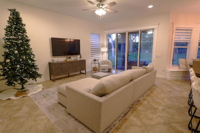 living room featuring ceiling fan and light tile patterned floors