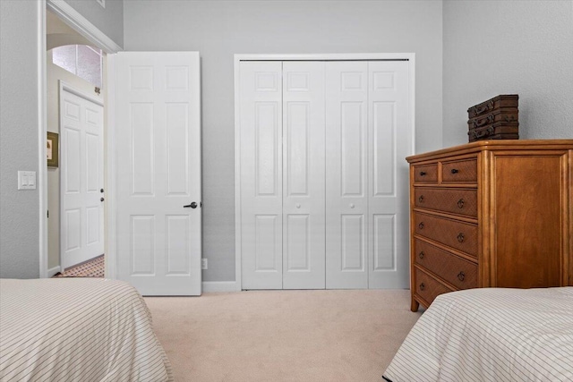 carpeted bedroom featuring a closet