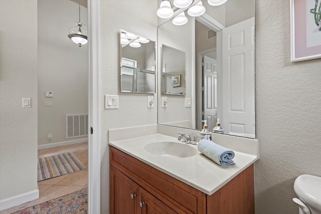 bathroom featuring tile patterned floors, vanity, and toilet