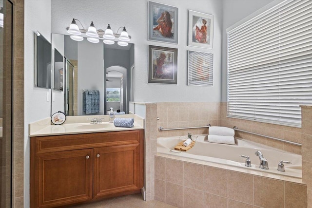 bathroom with plus walk in shower and vanity