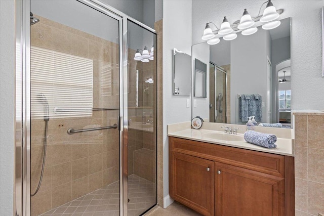 bathroom featuring vanity and a shower with shower door