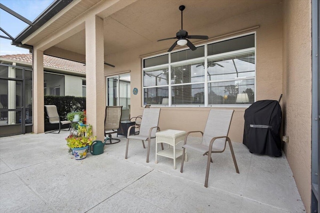 view of patio with area for grilling, ceiling fan, and a lanai