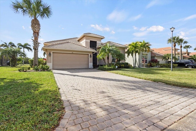 mediterranean / spanish house with a garage and a front lawn