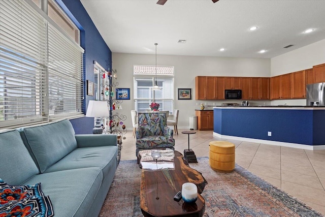 tiled living room featuring ceiling fan