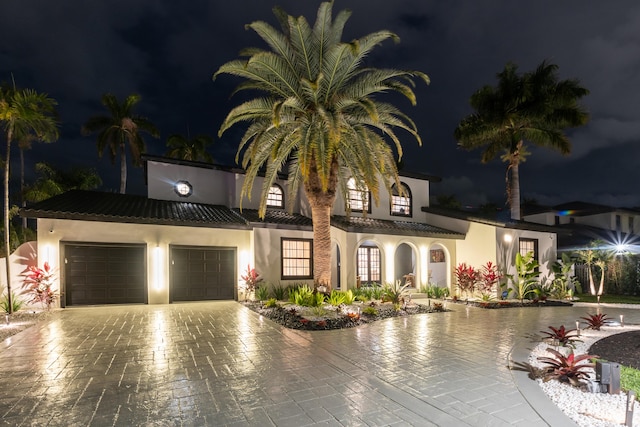 mediterranean / spanish-style house featuring a garage