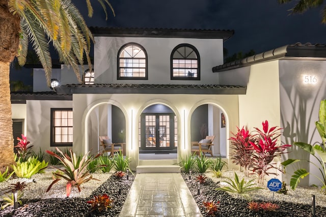 back of property featuring a porch and french doors