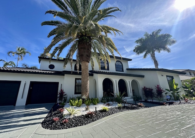 mediterranean / spanish-style home featuring a garage