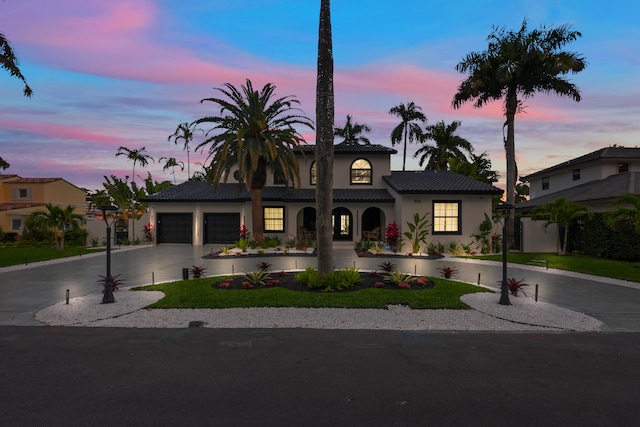 mediterranean / spanish house with a garage