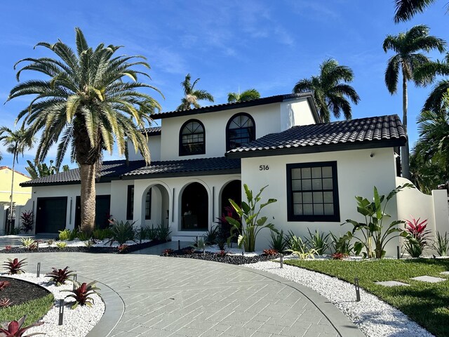 mediterranean / spanish-style home featuring a garage