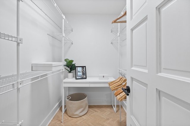 spacious closet with light parquet floors