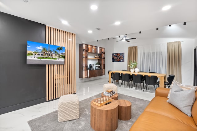 living room with lofted ceiling and ceiling fan