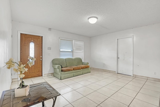 living room featuring a textured ceiling and light tile patterned floors