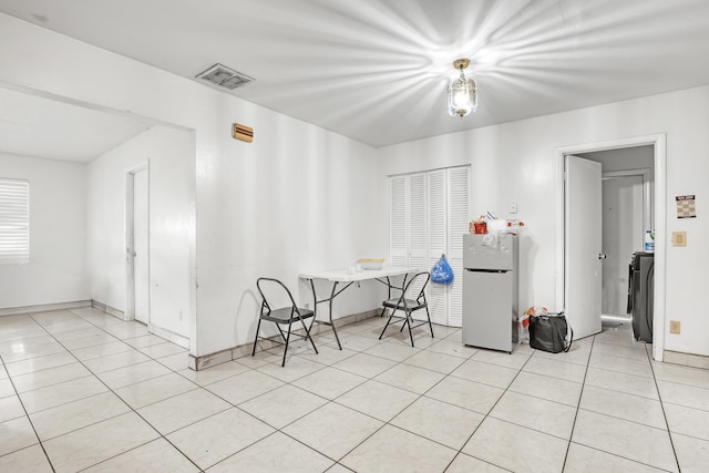 unfurnished dining area featuring light tile patterned floors