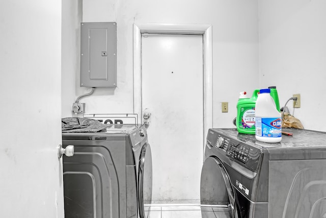 laundry room with electric panel, separate washer and dryer, and tile patterned flooring