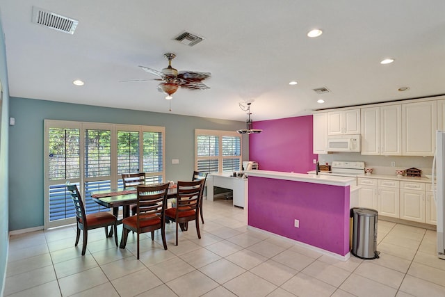 kitchen with white appliances, ceiling fan, a healthy amount of sunlight, decorative light fixtures, and white cabinetry