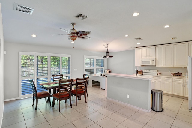 kitchen featuring white appliances, ceiling fan, decorative light fixtures, a healthy amount of sunlight, and white cabinetry