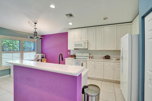 kitchen featuring white appliances, pendant lighting, white cabinets, a center island, and light tile patterned flooring