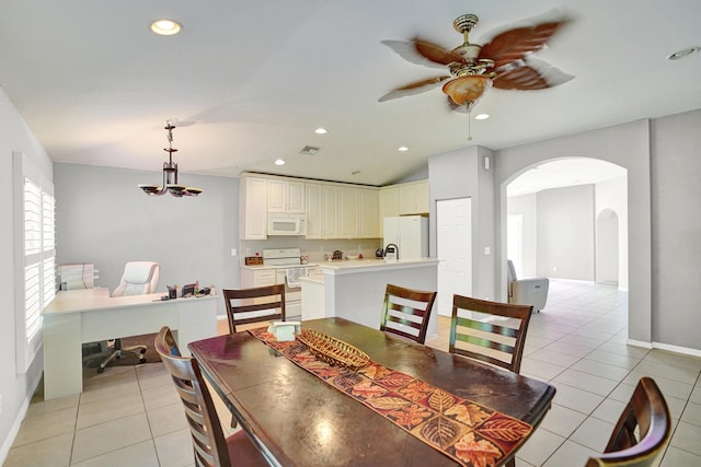 dining space with ceiling fan, light tile patterned flooring, and lofted ceiling