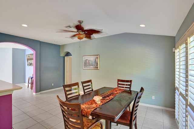 tiled dining area featuring ceiling fan and lofted ceiling