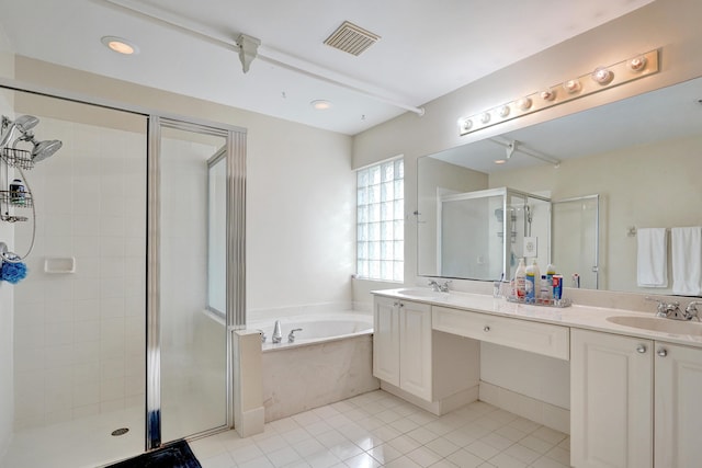 bathroom with tile patterned flooring, vanity, and shower with separate bathtub