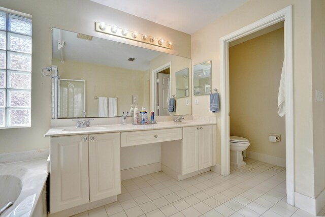 full bathroom with tile patterned flooring, vanity, toilet, and plenty of natural light