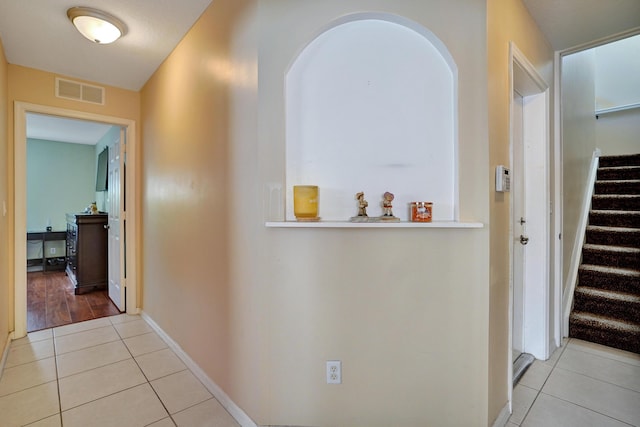 corridor featuring light tile patterned flooring