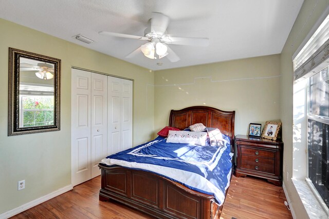 bedroom featuring ceiling fan, a closet, and wood-type flooring