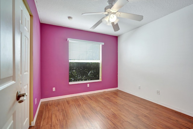 empty room featuring ceiling fan, light hardwood / wood-style floors, and a textured ceiling