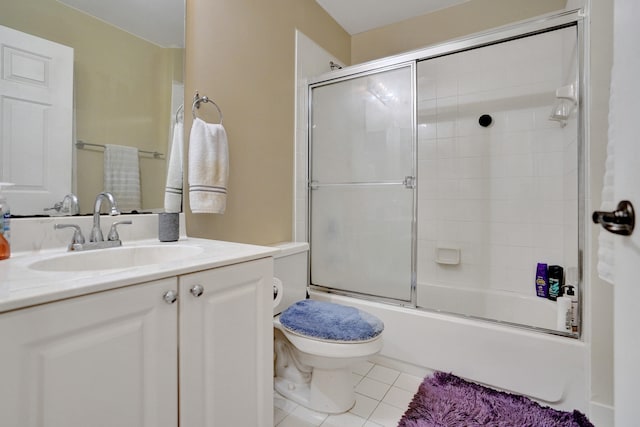 full bathroom with toilet, vanity, tile patterned floors, and combined bath / shower with glass door