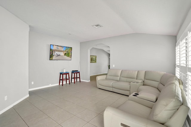 living room with light tile patterned flooring and lofted ceiling