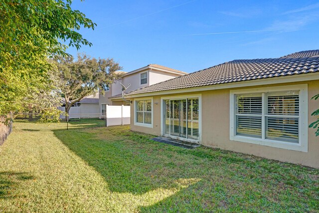 rear view of property with a yard