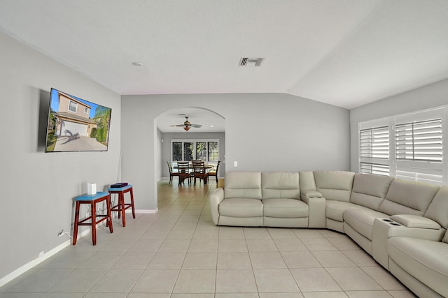 living room featuring ceiling fan, plenty of natural light, and light tile patterned floors