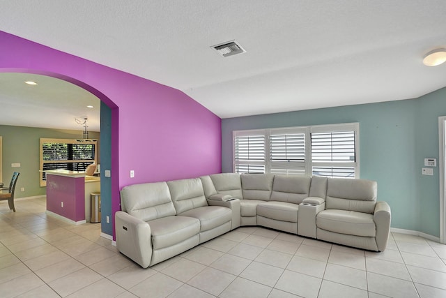 living room featuring light tile patterned floors and lofted ceiling